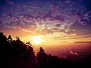 Magical sunrise landscape over the city with fog