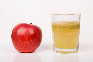 Red apples and a glass of fresh juice isolated on white background