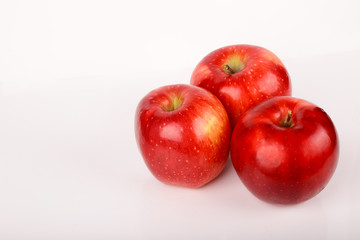 Three red apples isolated on white background
