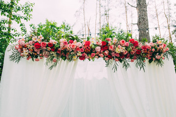 Flowers on the wedding arch, ceremony decorations.