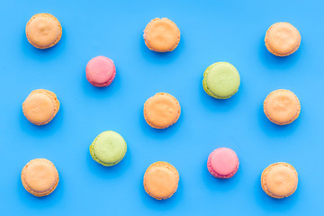 Macarons dessert. Pattern on blue pastel background top view