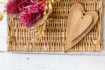 Red flowers and wooden hearts