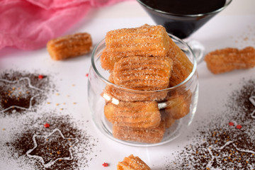 Spanish cookies Churros in a glass jar and chocolate sauce