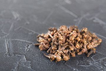 spices carnations on a black background a lot