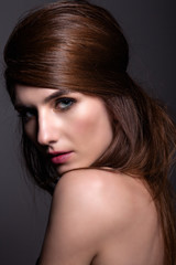 Fototapeta premium Portrait of a beautiful woman on a gray background.