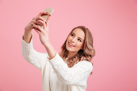 Pretty woman make selfie by mobile phone.