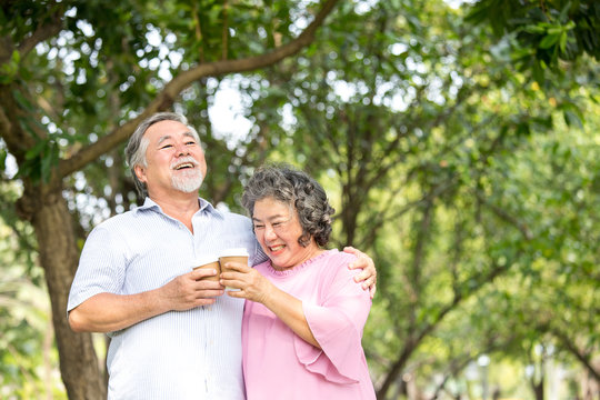 Asian Senior couple smiling together at outdoor park. People lifestyle concept.