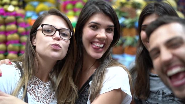 Friends taking a selfie with mobile in a Municipal Market, Sao Paulo, Brazil