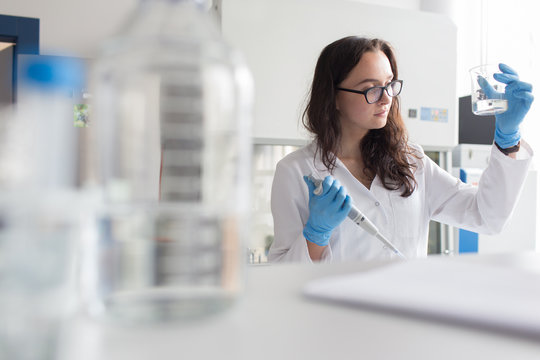Woman holding flask in lab