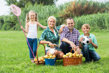 Family of four resting at countryside.