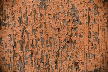 Old orange painted cracked wooden surface texture background