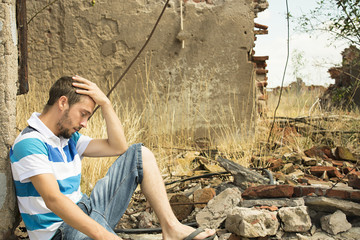 Thoughtful man sitting in a window.