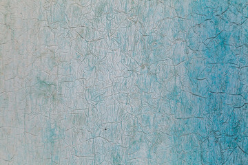 Texture of peeling paint on wall with white and blue gradient