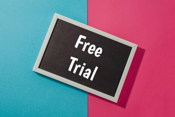Free trial - text on chalkboard on blue and pink bright background.