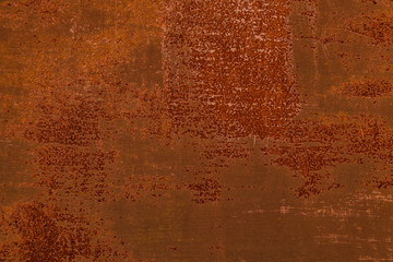 Heavily worn red peeled rusty metal wall with remains of old paint. Texture for background