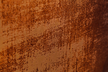 Heavily worn red peeled rusty metal wall with remains of old paint. Texture for background