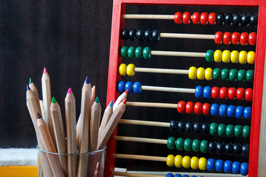 everything you need for school. plasticine, chalk, felts, notebooks, pencils, paints, compass and stapler are lying on wooden background. stationery for school