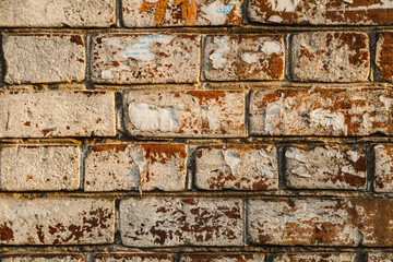 Old brick dirty wall loft style with remains of old paint
