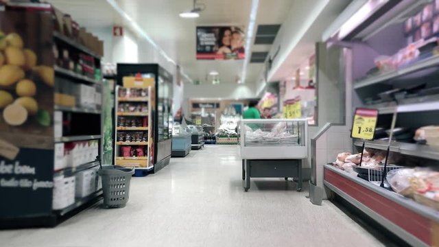 Supermarket Shopping Products Slow Motion. Slow motion of a shopping cart in the supermarket aisle with products and people
