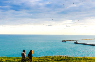 Naklejka premium Evening walk at the White Cliffs of Dover overlooking the port by the English Channel