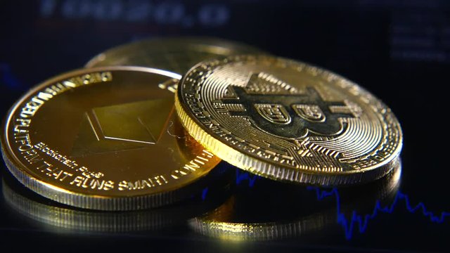 Golden bitcoins on the background of a graphic stock chart. The Concentration of the Crypto-Currency of Virtual Money