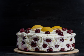 jelly cake with cherries on a wooden background.