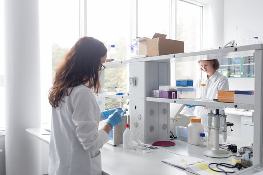 Women standing and working in lab