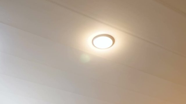 The inclusion of energy-saving lamps on the ceiling in the room. 4K.