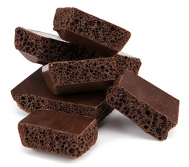 Dark porous chocolate isolated on white background