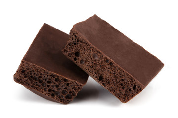Dark porous chocolate isolated on white background