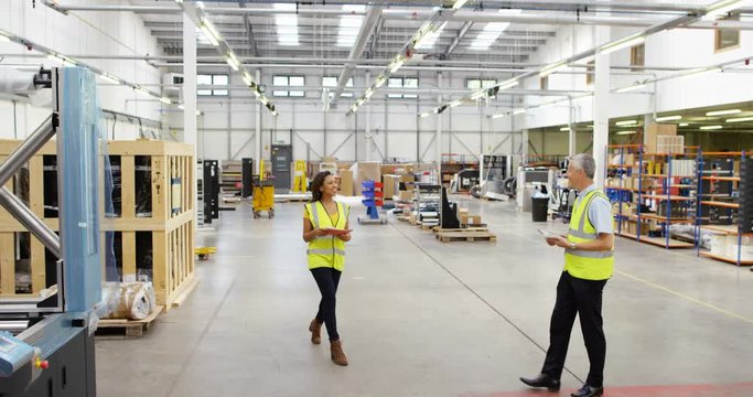 4k, Shot of two coworkers shake hands and inspect inventory in a distribution. SLow motion.