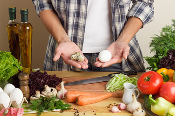 Woman is cooking at the kitchen