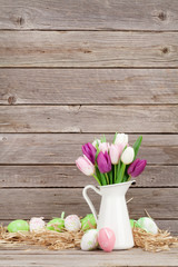 Obraz premium Easter eggs and colorful tulips bouquet