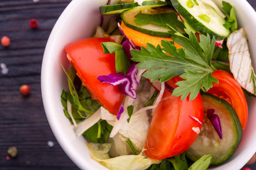 Vegetables and greens salad, with tomatoes and cucumbers