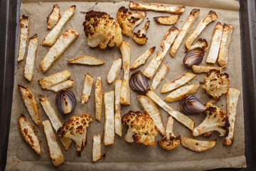 baked vegetables on a baking sheet - celery, cauliflower and red onion