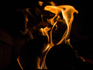 Burning woodfire in a fireplace on a black background
