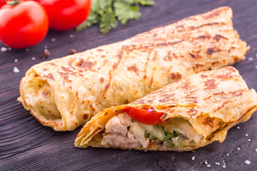 Wrapped up beaters with meat, are served with vegetables and greens