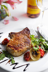 Grilled beefsteaks and vegetables