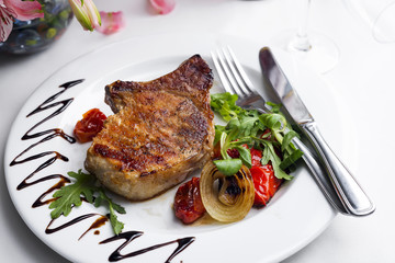 Grilled beefsteaks and vegetables