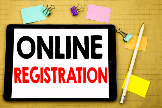 Hand writing text caption inspiration showing Online Registration. Business concept for Internet Login Written on tablet laptop, wooden background with sticky note and pen