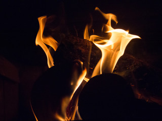 Burning woodfire in a fireplace on a black background