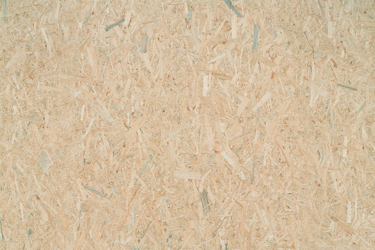 OSB - oriented strand board or QSB - quality strand board, chipboard texture or chipboard background image. OSB or QSB construction panel surface.