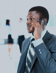 smiling businessman on the phone in his office.