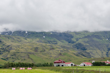 Icelandic farm beneath mountains