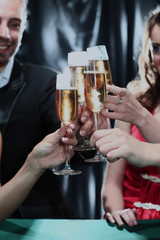 Image of human hands holding the glasses of champagne making a toast.