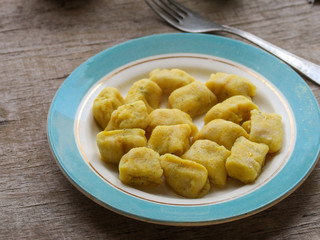 gnocchi in a plate on a wooden table