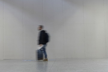 blurry person walking in the airport