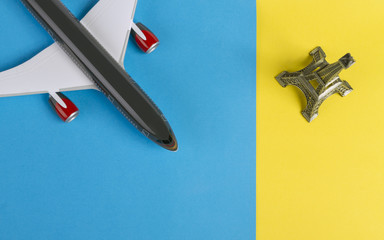 airplane and eiffel tower on blue and yellow background © Ayman Alakhras