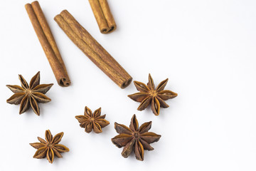 Spices: star anise and cinnamon sticks on white background. Close up.