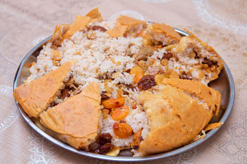 Shah Pilaf with fire on a table in restaurant . Shah pilaf. Khan pilaf in a pita. Pilaff . Pilau . Pilaw . Traditional oriental dish . on tableware . Azerbaijan , Baku .